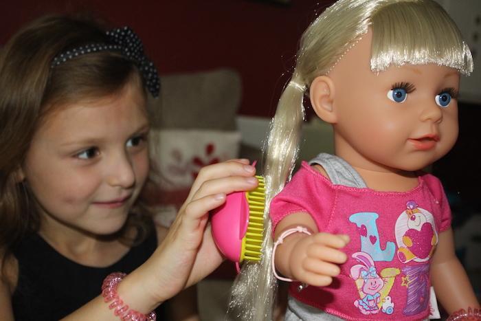 Bella brushing doll's hair