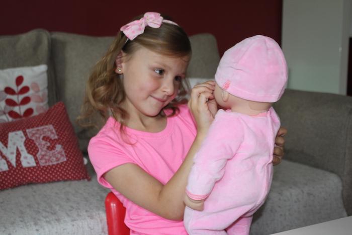 Bella stroking Baby Annabell's cheek
