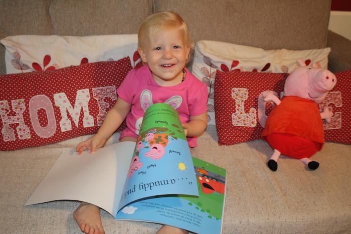 Sienna happy with her Peppa Pig book