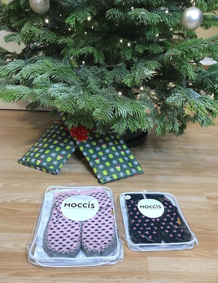 2 Pair of Quality Hand-Sewn Scandinavia Moccis inside packaging under a Christmas Tree