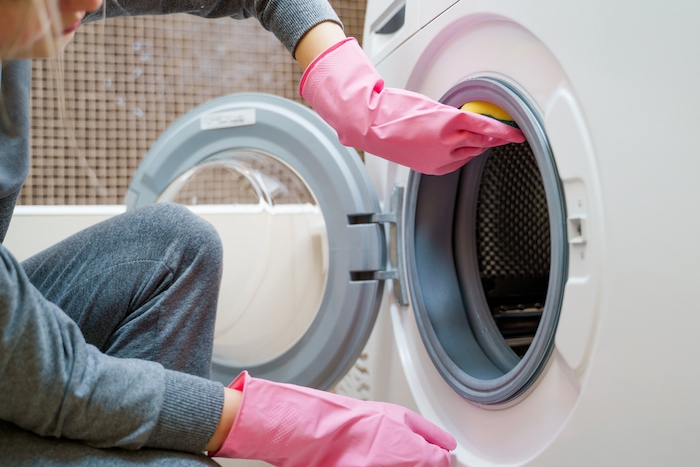 lady cleaning a washing machine