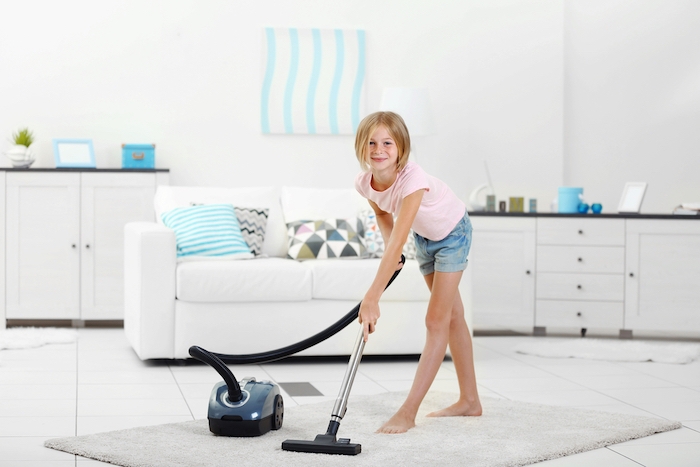 little girl with a vacuum cleaner