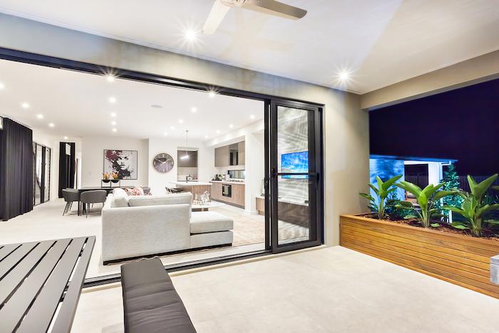 Modern living room is attached to the patio area from the outside through the glass door