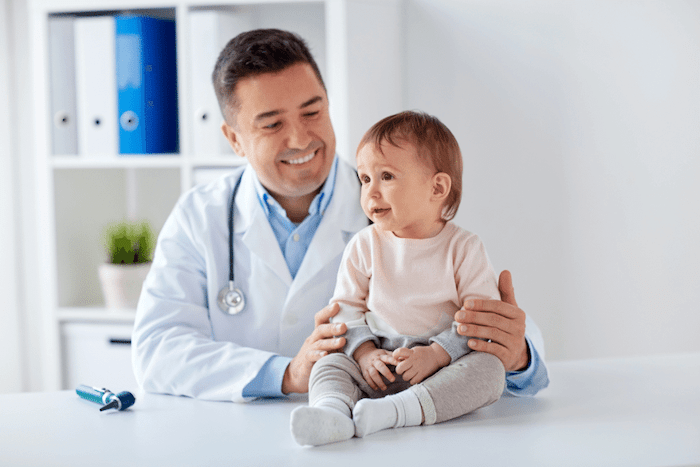 pediatrician with young child at doctor's appointment