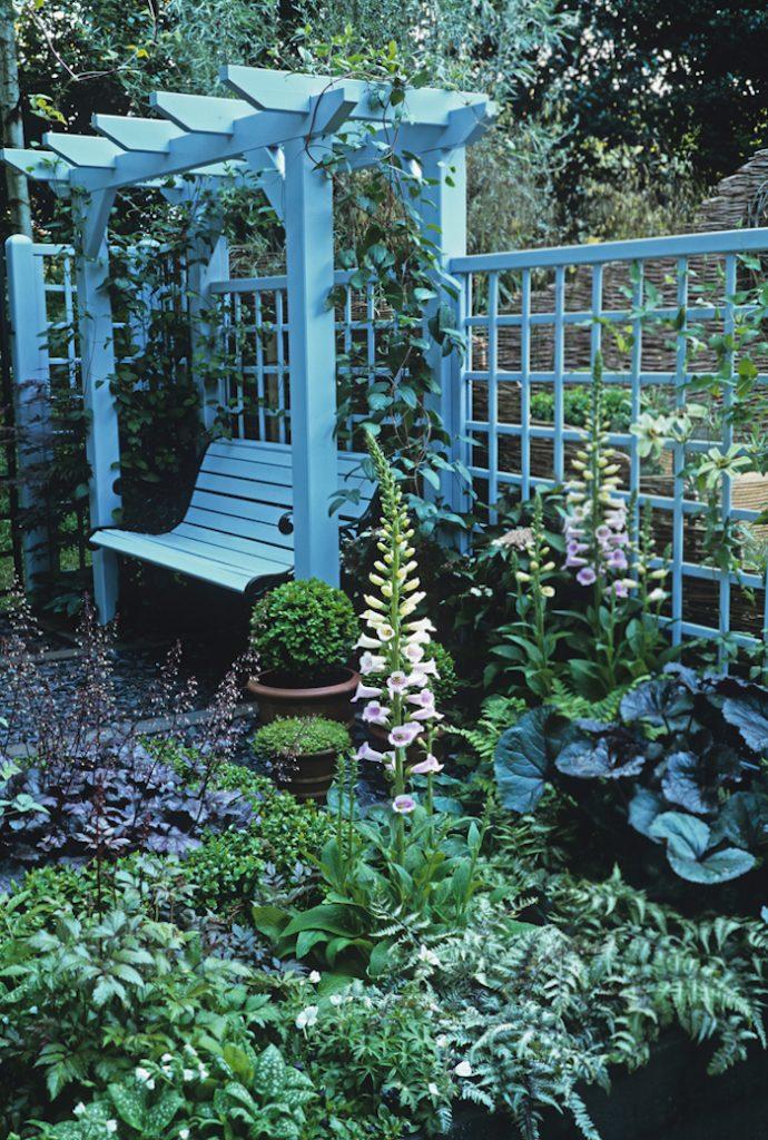 Seat under pergola in 'Simple Harmony' garden at Chelsea