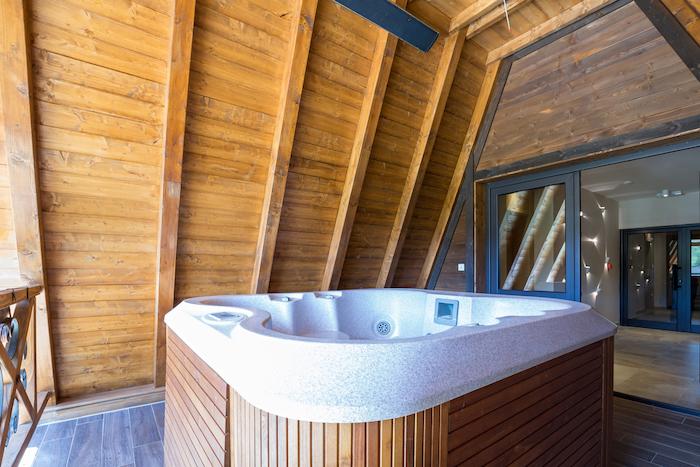 Hot tub with wooden frame on mountain hotel terrace