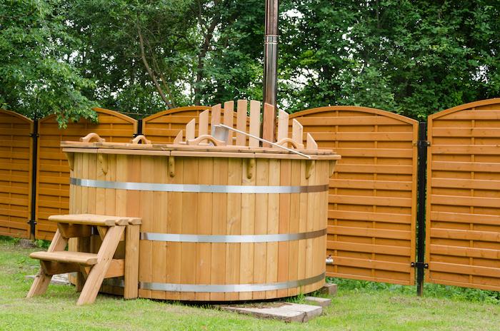 modern new wooden water spa hot tub with stairs outdoor