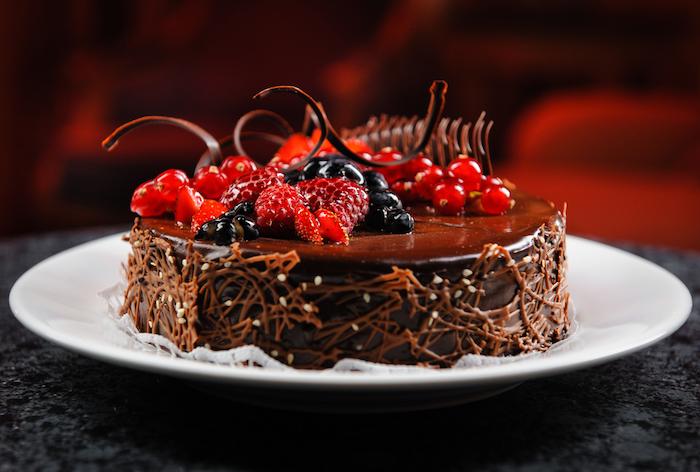 Luscious chocolate cake with fresh berries on a plate
