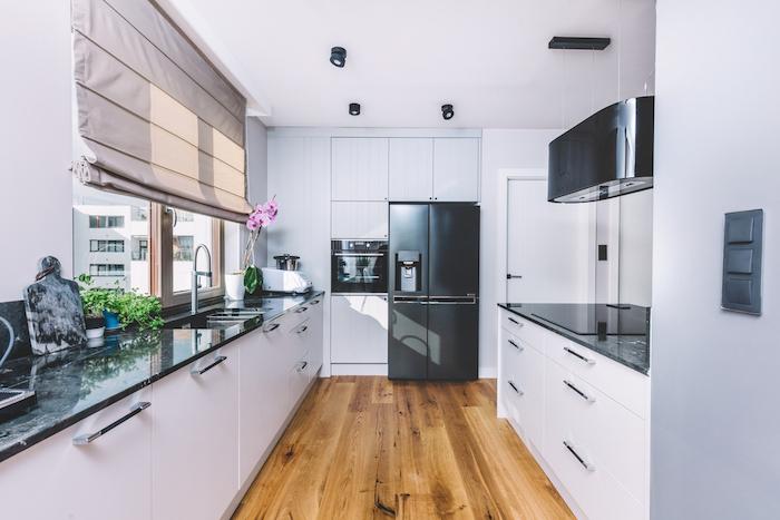Modern kitchen interior design. Wooden floor and quartzite tabletop