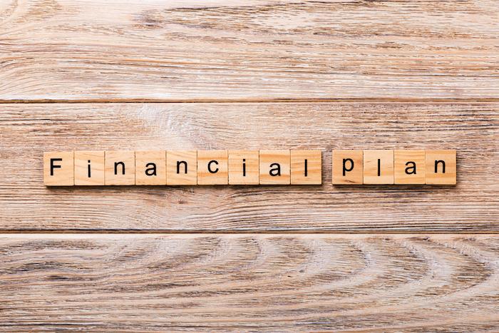 financial plan word written on wood block. financial plan text on wooden table for your desing, concept.