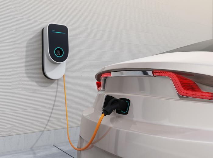 White electric car charging at home