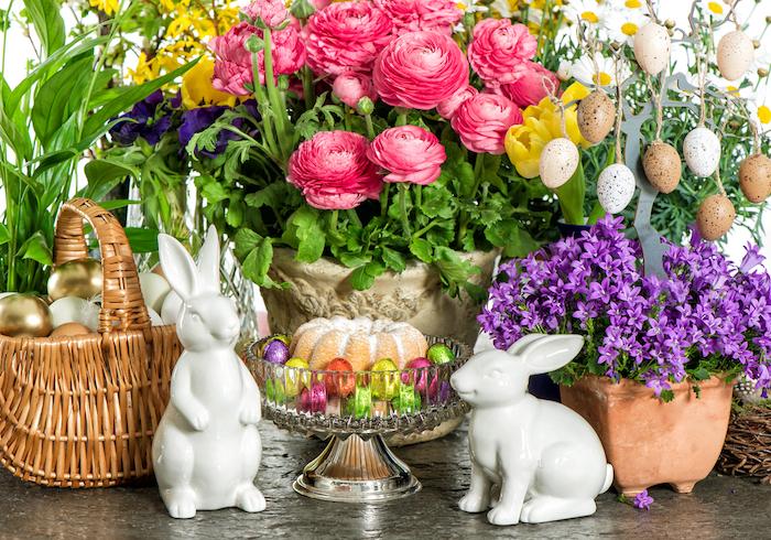 Easter cake, spring flowers, eggs and bunnies. Festive home interior decoration