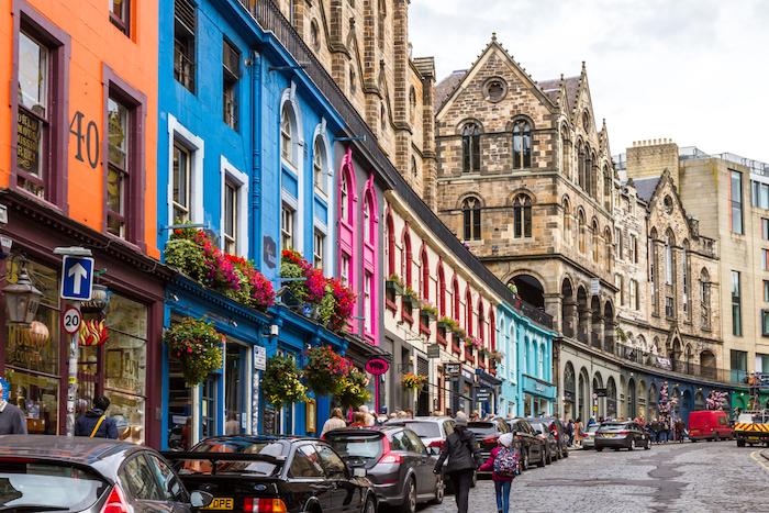 People walking on the sidewalks of old town Edinburgh, UK 