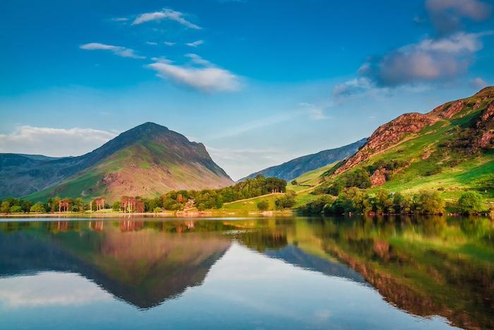 How To Stay Safe In The Lakes During Storms & Bad Weather. Beautiful sunset at lake in District Lake, UK