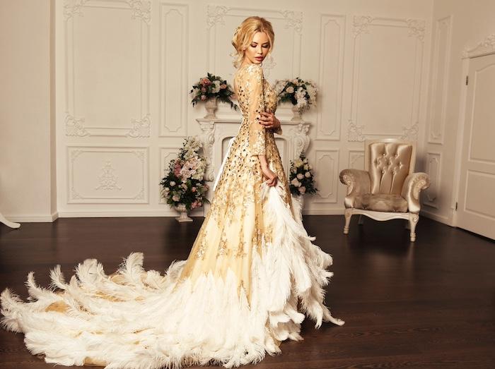 A Guide to Dressing for a Special Event. fFashion interior photo of gorgeous young woman with blond hair in luxurious beige dress posing at bedroom