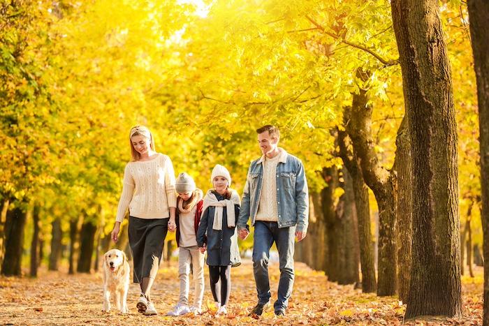 Happy family walking in autumn park