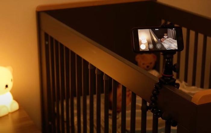 Cot with a baby monitor app via a mobile phone