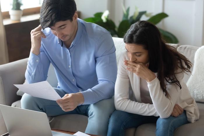 Separated couple studying financial documents