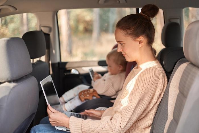portrait-woman-wearing-beige-jumper-working-laptop-looking-display-typing