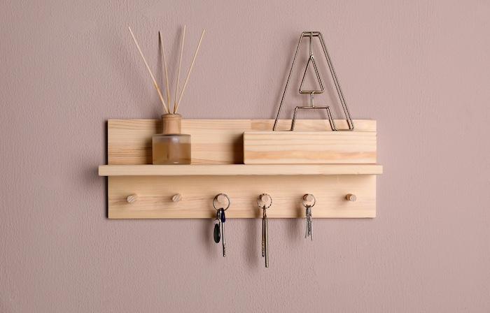 Wooden hanger for keys on color wall