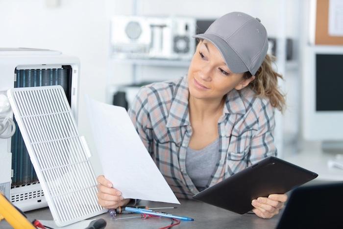 Female repairing air conditioner
