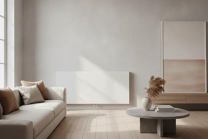 Tall vertical radiator in a stylish small modern flat, slim white design, positioned beside a window with compact contemporary furniture, warm neutral tones, natural daylight.
