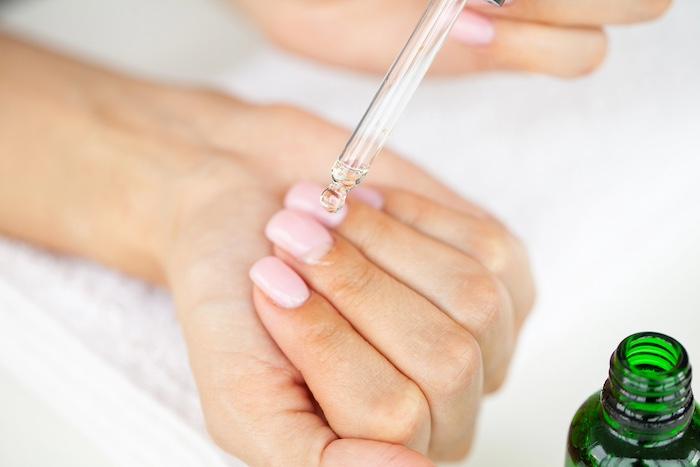Closeup of beautiful woman hands getting manicure at home