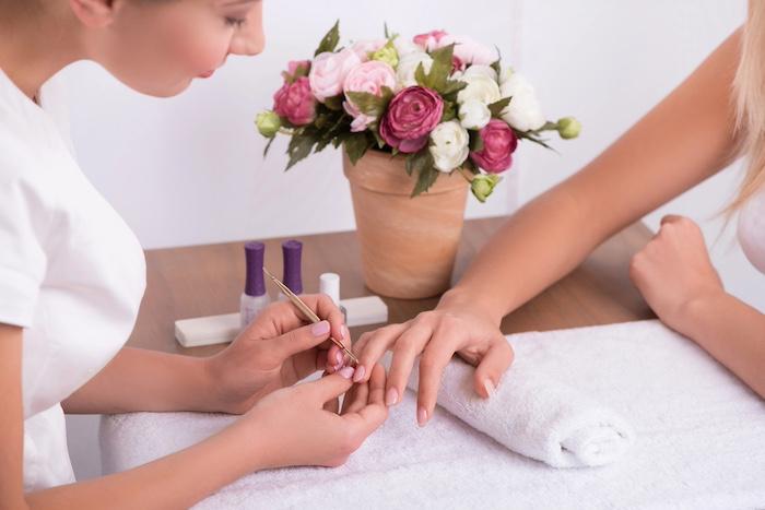 Client and manicurist in manicure salon
